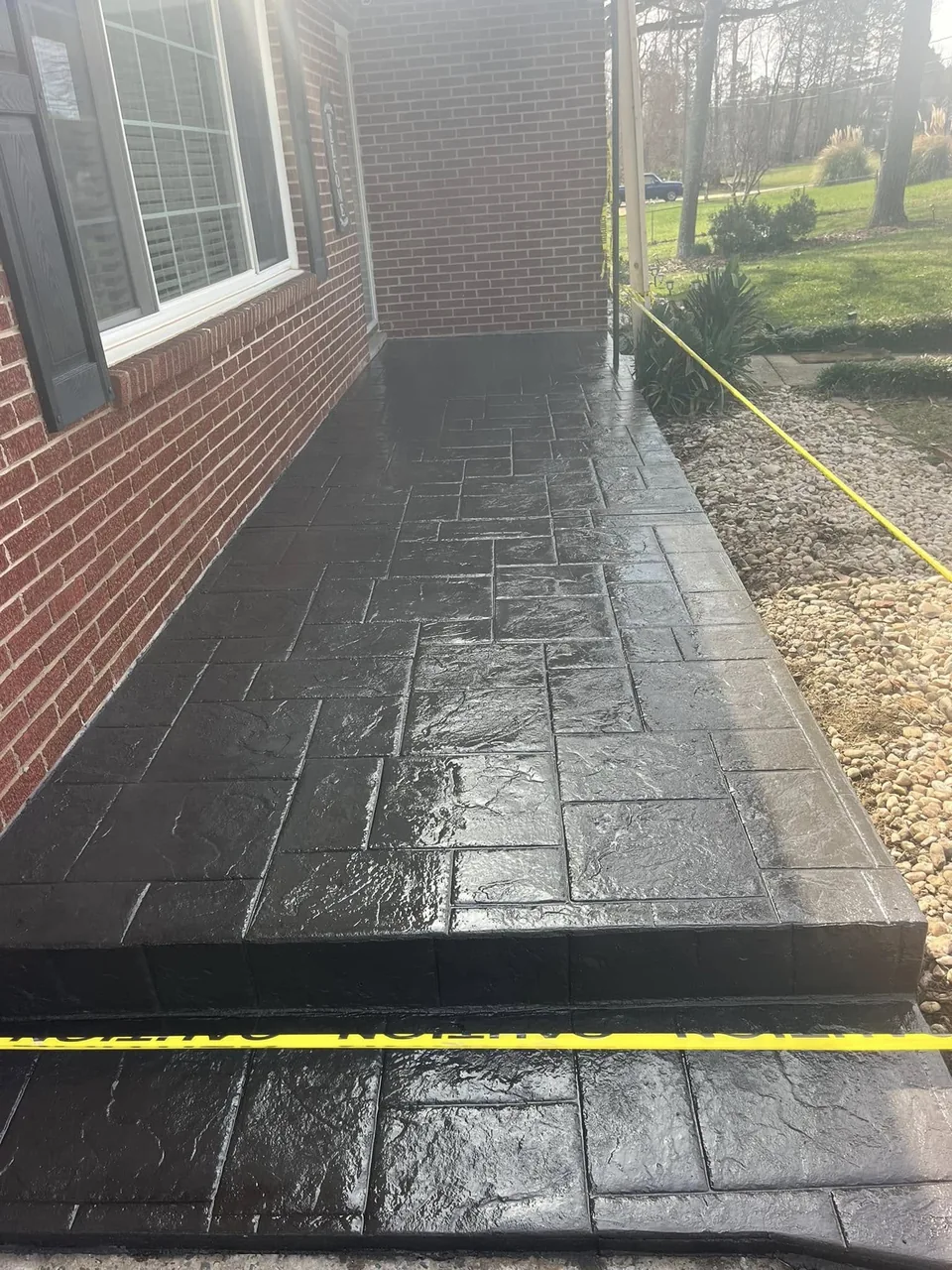 Dark stamped concrete front walk and landing
