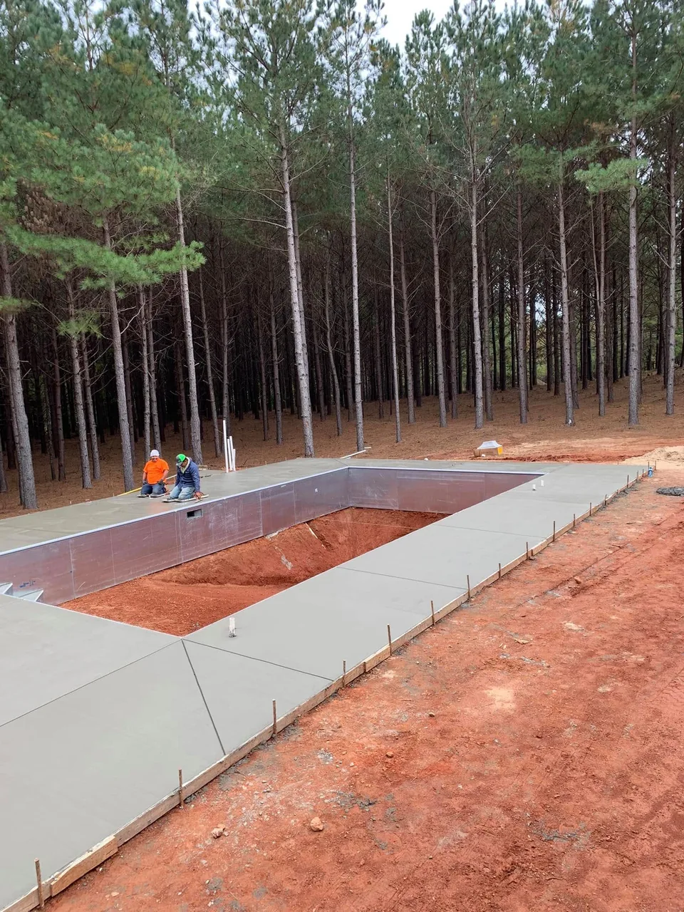 Concrete pool surround with clean edges and drainage slope
