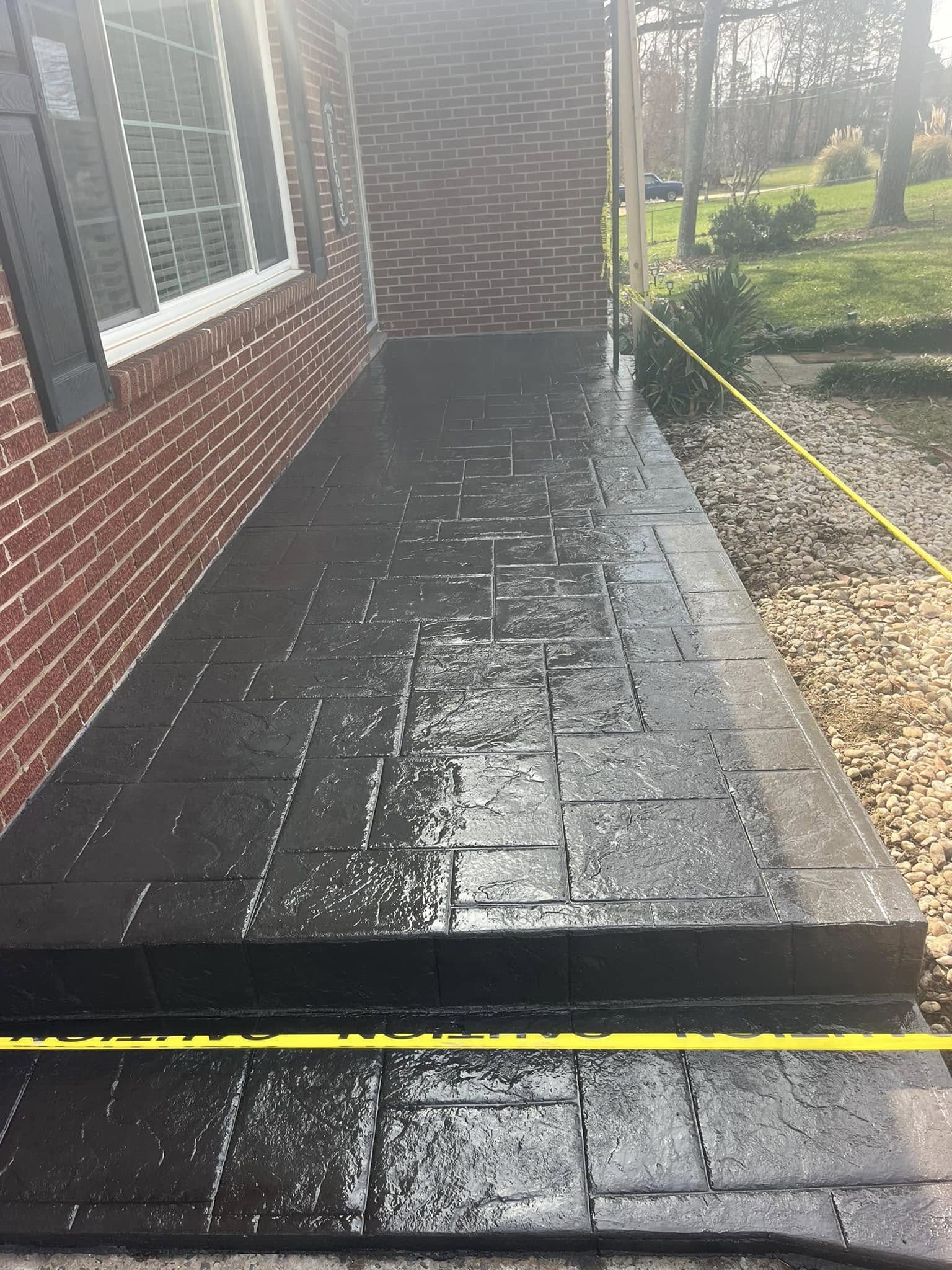 Dark stamped concrete front walk and landing