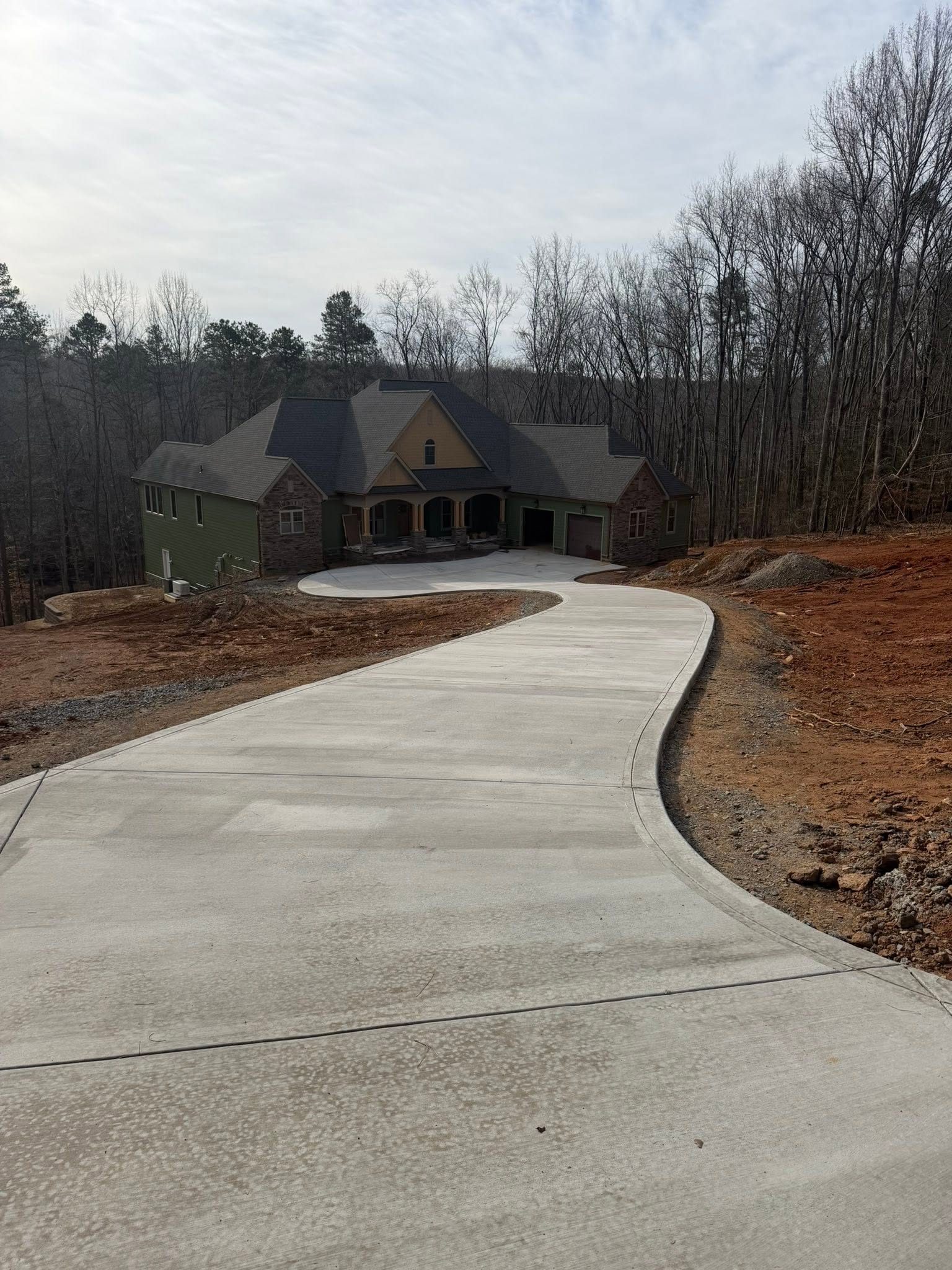 Curved concrete driveway for a rural home